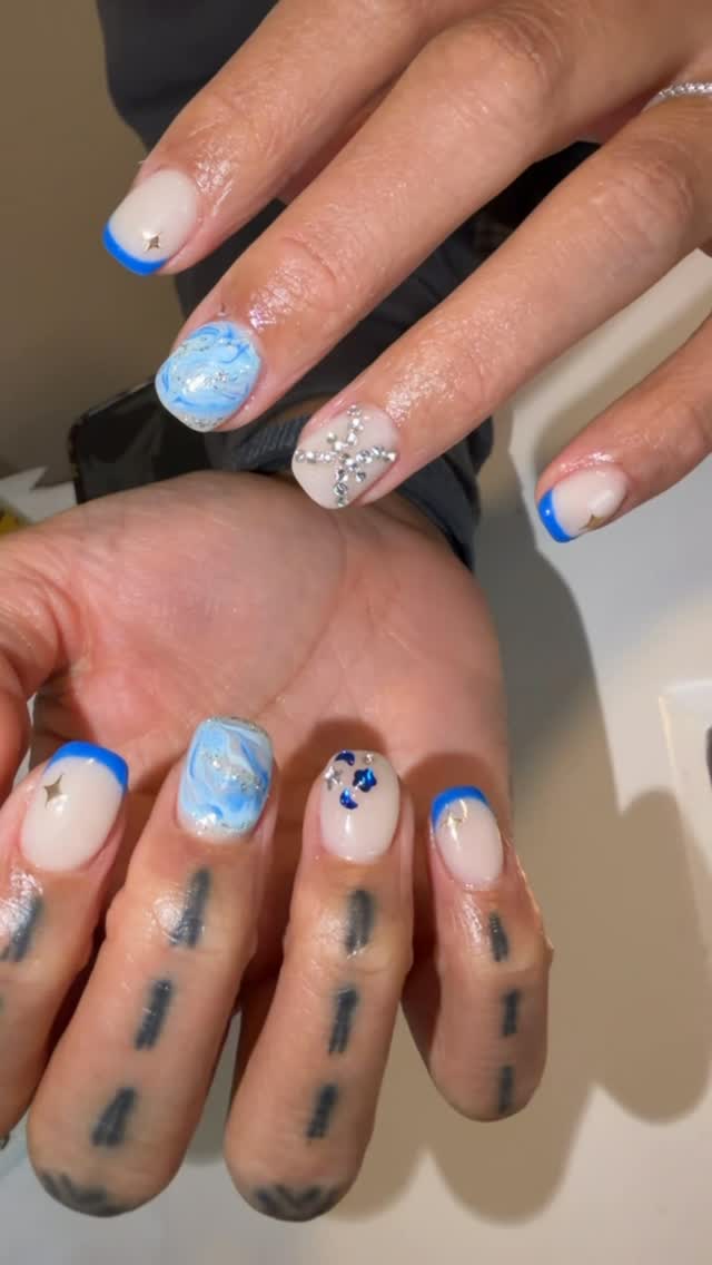 Blue French tips with marble art and crystal details by Nails By Rajvir