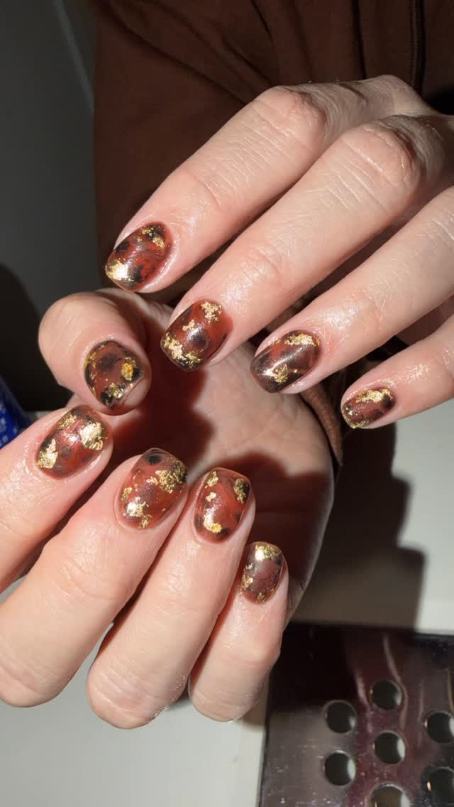 Tortoiseshell nails with gold foil accents by Nails By Rajvir